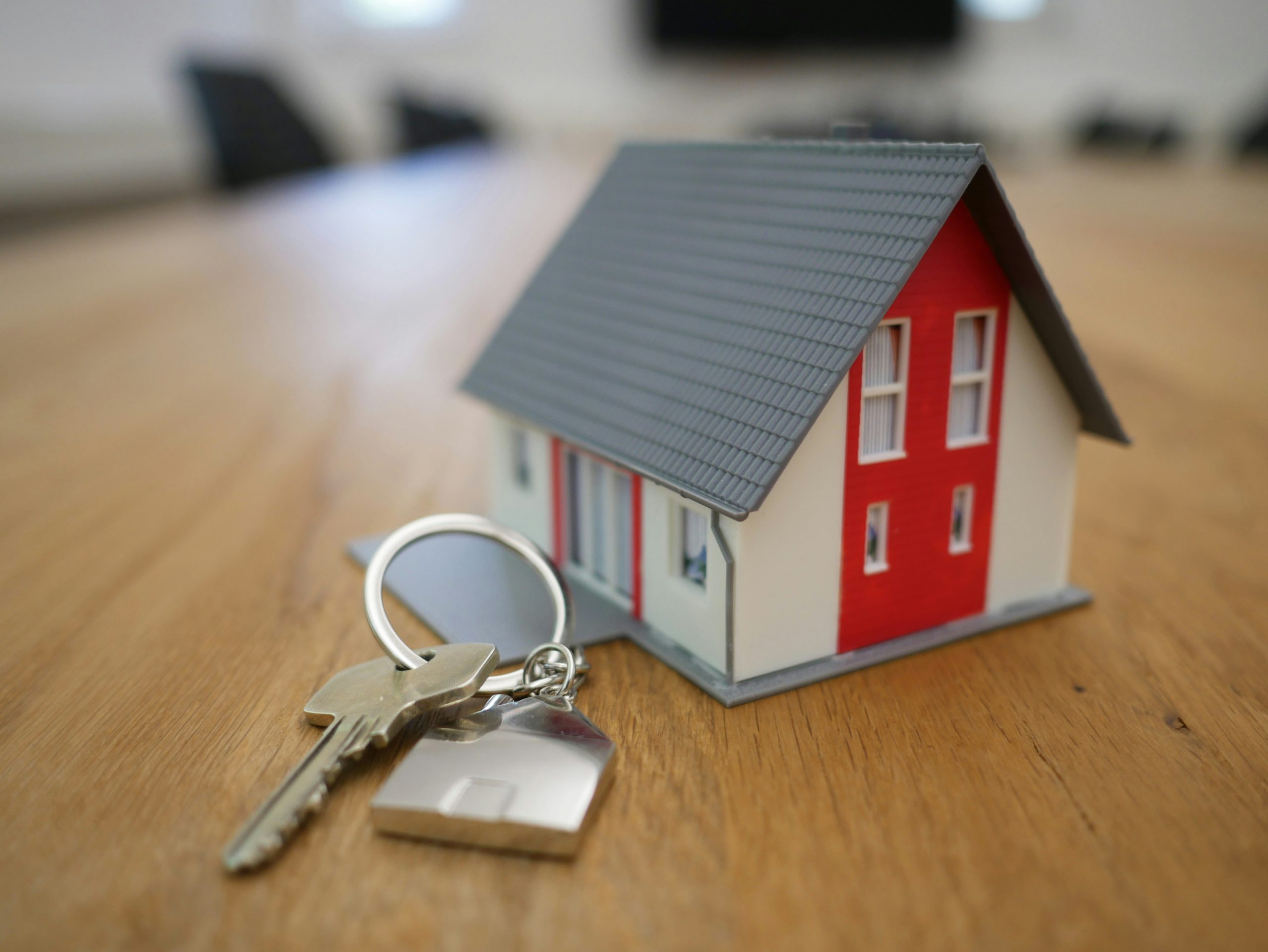 small cutout house next to set of house keys