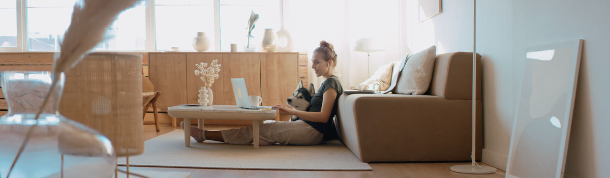 Caucasian female working from home michigan, having a video work call, making notes.